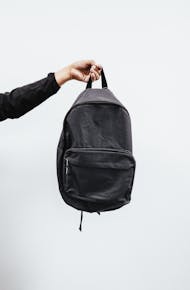 Person Holding Black Backpack