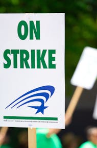 People Rallying Carrying on Strike Signage