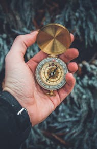 Person Holding Compass