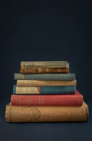 An elegant stack of vintage books creates a classic and timeless feel.